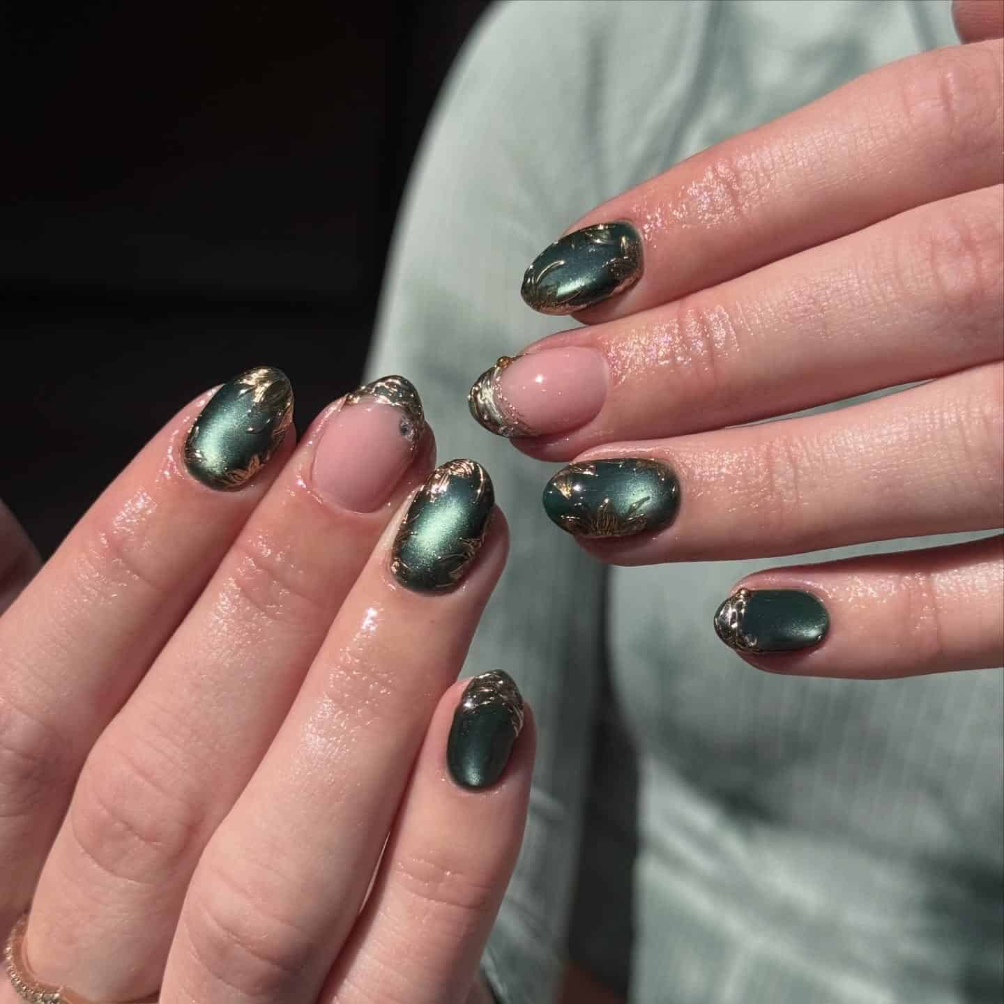 20. Dark Green Cat Eye Nails with Gold Chrome Accents - green and gold nail ideas