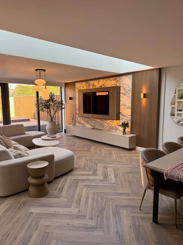 2. Modern Beige Entertainment Center with Marble Accent Wall - living room entertainment center ideas