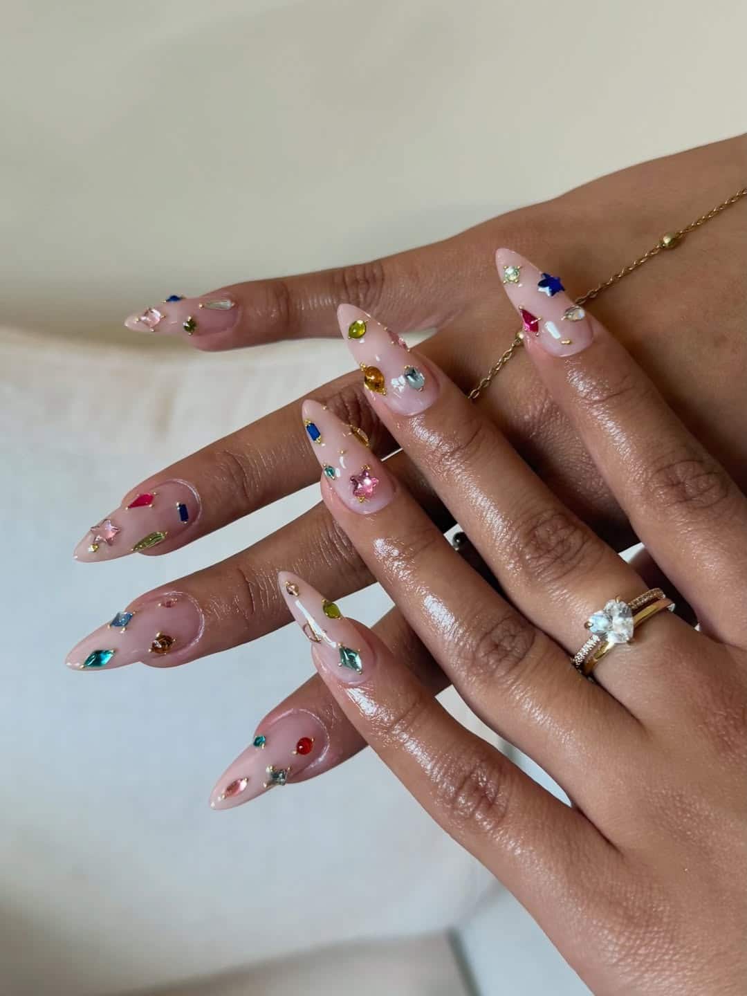 2. Colorful Statement Gem Nails with a Sheer Pink Base - nail ideas with gems