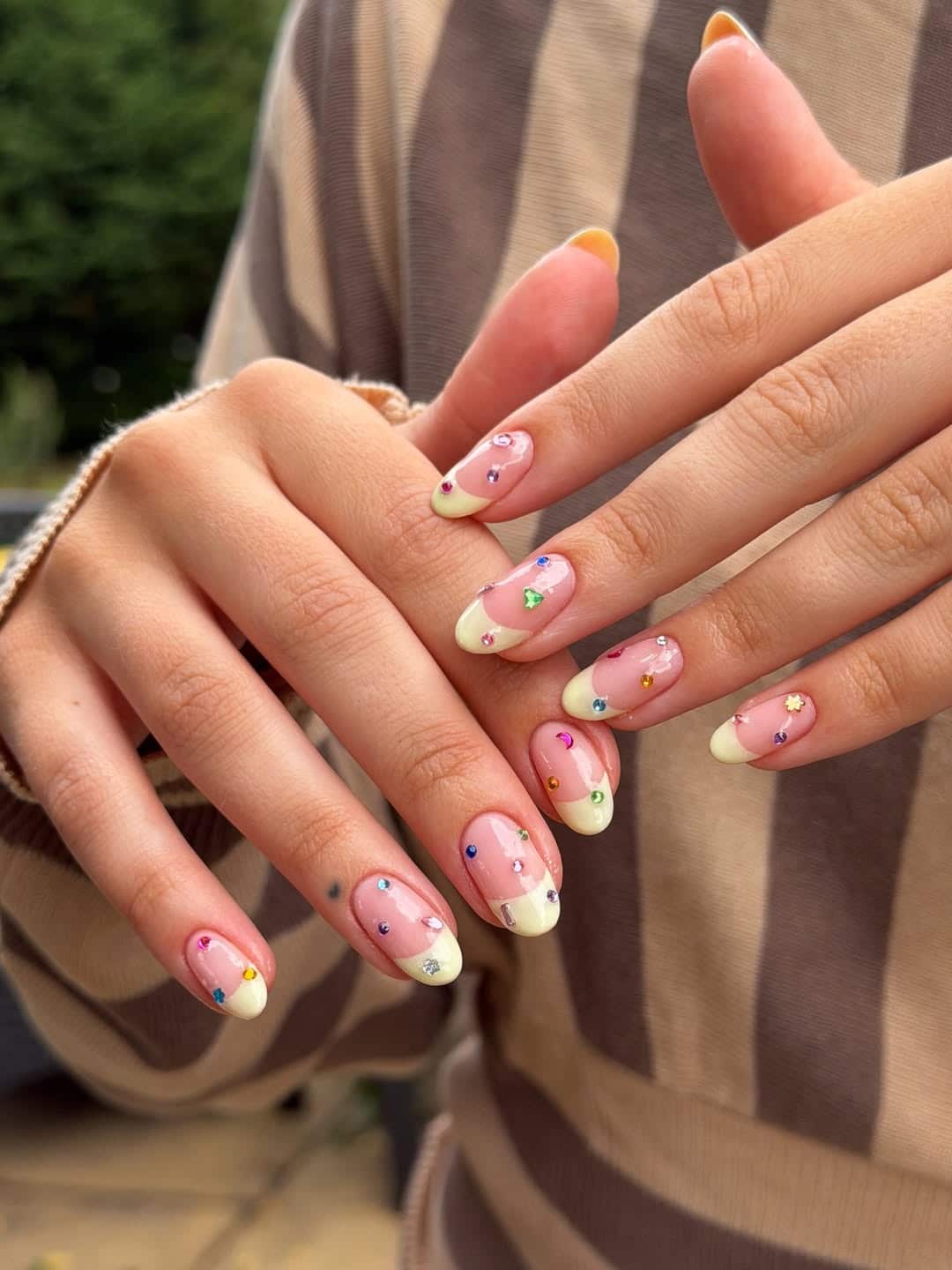 3. Soft Yellow French Tip Nails with Rainbow Gems - nail ideas with gems