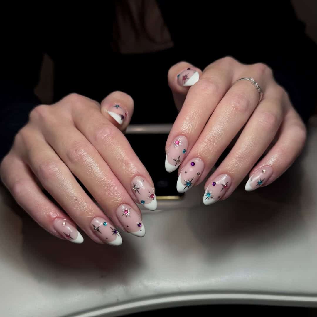 5. White French Tip Nails with Colorful Starburst Gems - nail ideas with gems