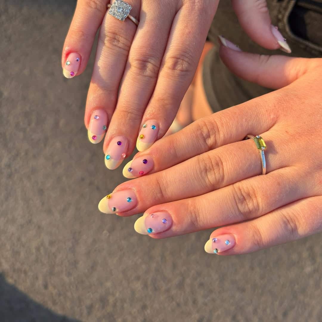 6. Pastel Yellow French Nails with Tiny Rainbow Crystals - nail ideas with gems