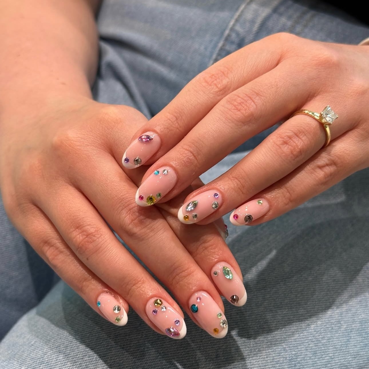 16. Blush Pink French Nails with Multicolored Statement Gems - nail ideas with gems