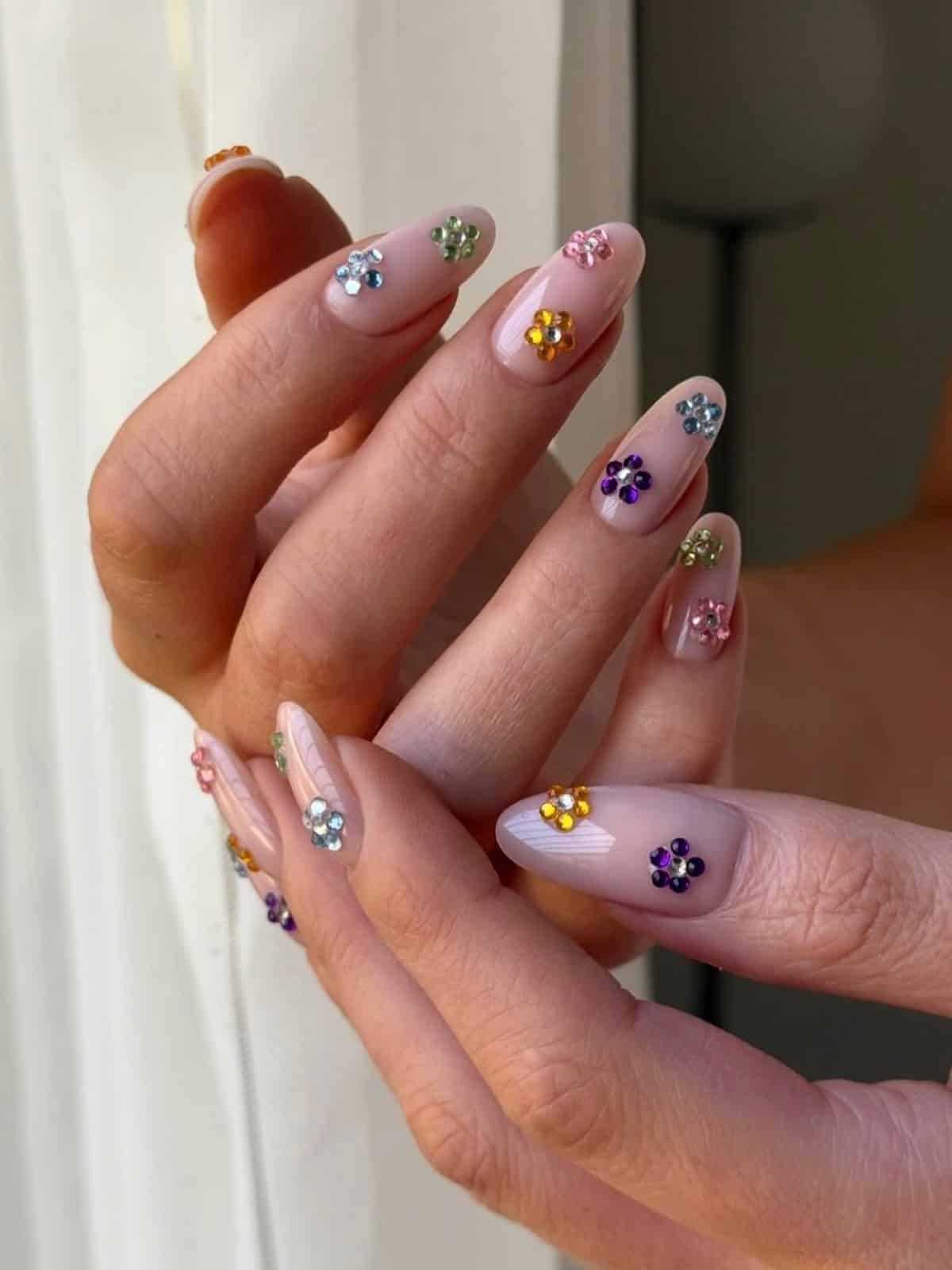 18. Pastel Pink Almond Nails with Colorful Gem Flowers - nail ideas with gems