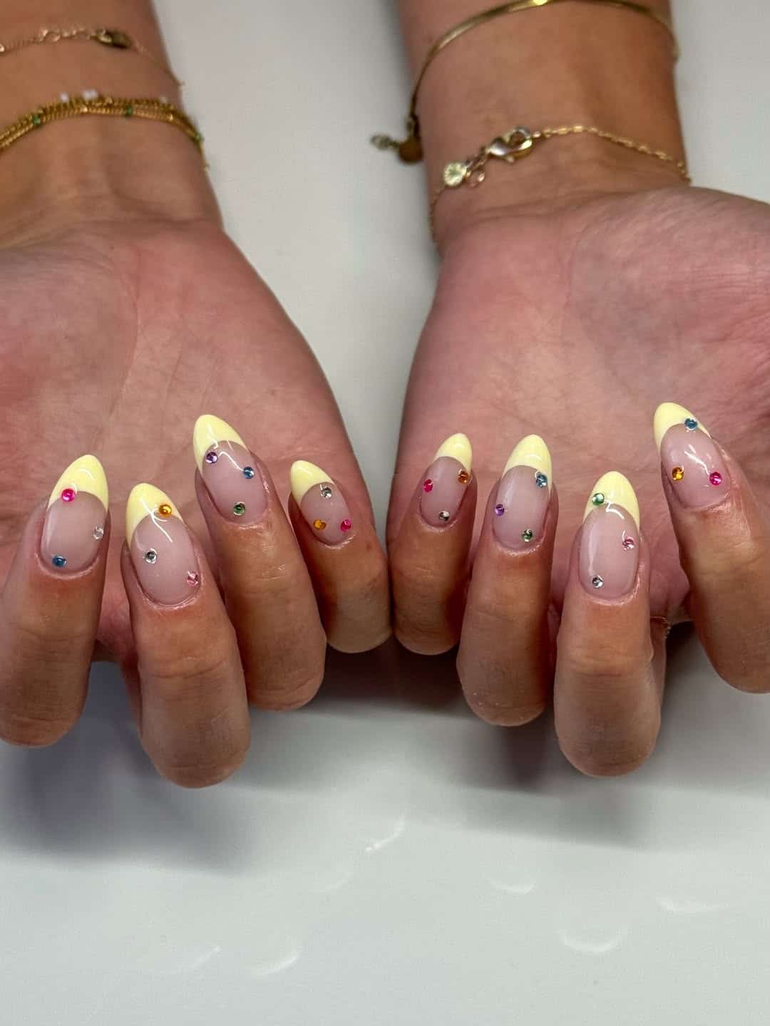 22. Pastel Yellow French Tip Nails with Colorful Rhinestones - nail ideas with gems