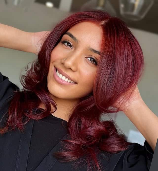 3. Deep Ruby Red Hair with Soft Feathered Layers - Red Hair Color