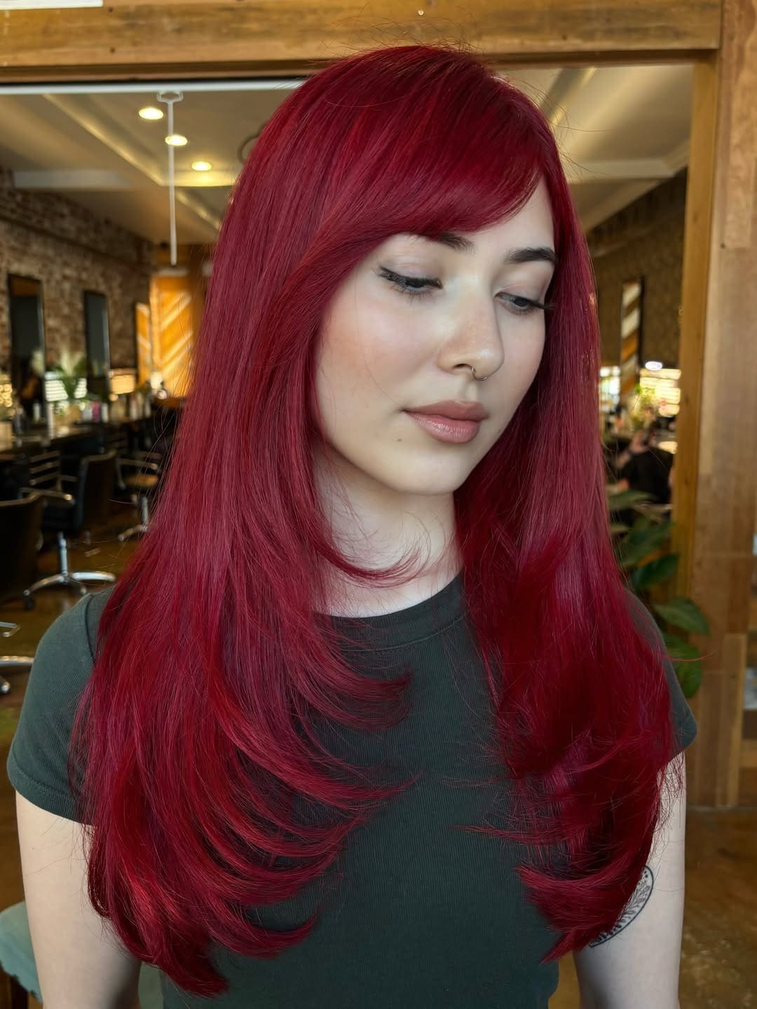 4. Rich Crimson Red Hair with Long Layers and Side Bangs - Red Hair Color