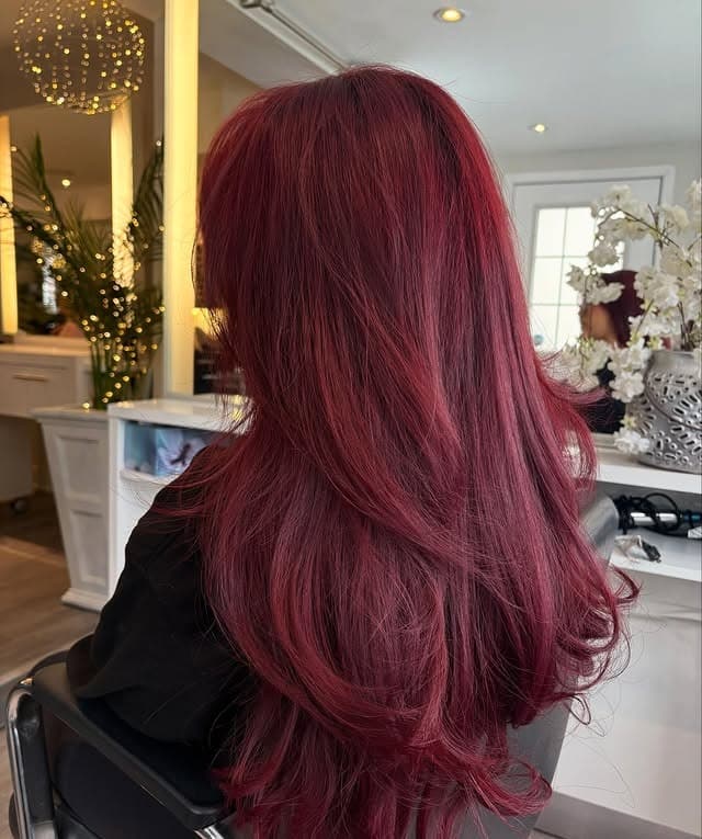 15. Vibrant Raspberry Red Hair with Long Feathered Layers - Red Hair Color
