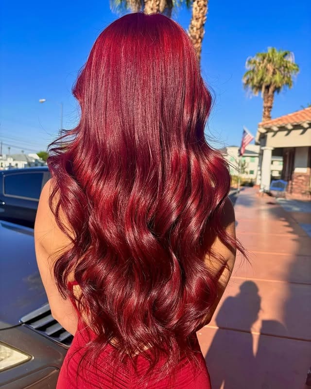 17. Radiant Ruby Red Hair with Long Glamorous Waves - Red Hair Color