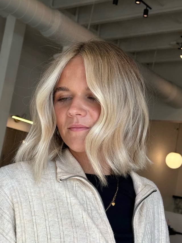 2. Icy Beige Blonde Wavy Bob with Curtain Bangs - Short Blonde Hairstyles