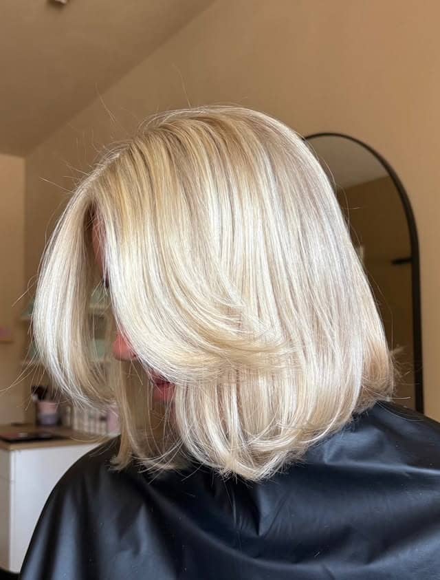 15. Icy Pearl Blonde Layered Bob with Feathered Ends - Short Blonde Hairstyles
