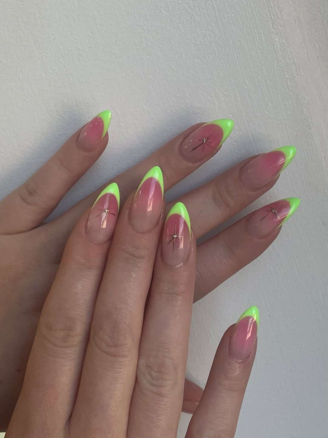 18. Neon Green French Tip Almond Nails with Silver Starbursts - neon green nail ideas