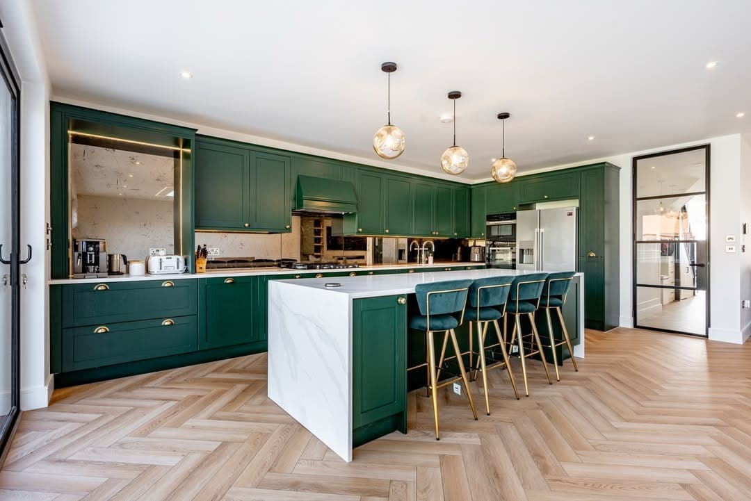 21. Elegant Emerald Green Kitchen with White Marble Island and Herringbone Floors - emerald green kitchen ideas
